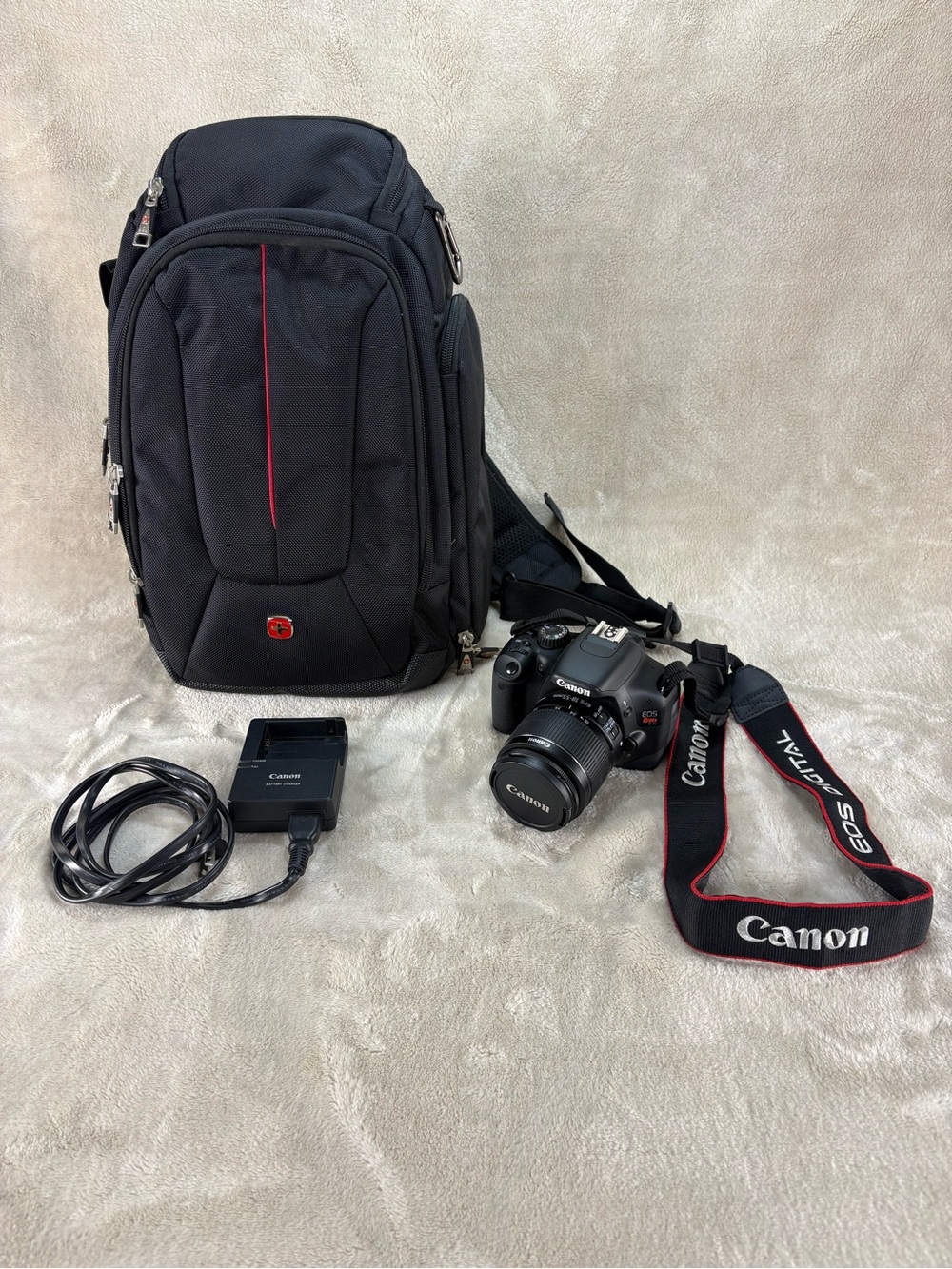 Canon EOS Rebel T2i DSLR Camera, Lens and Charger Kit with Swiss Gear sling bag